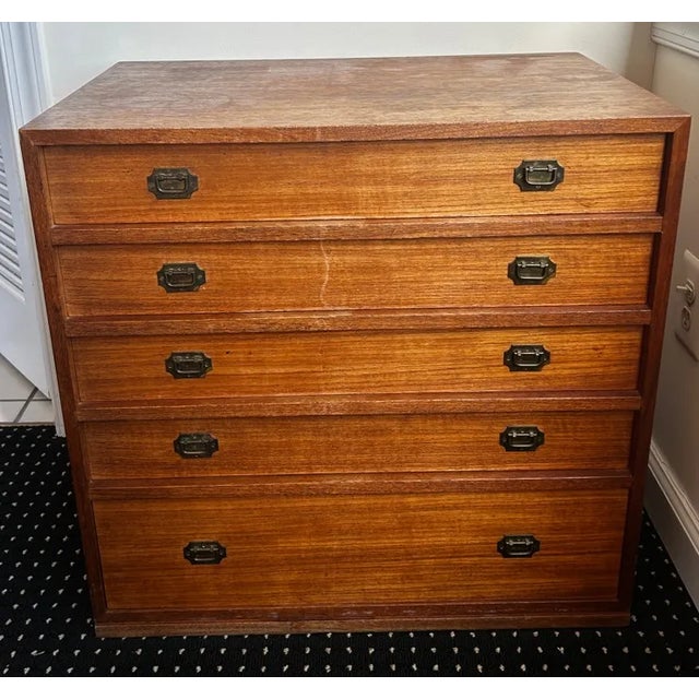 Beautiful vintage mid-century modern teak chest of drawers featuring stunning natural grain patterns and warm honey tones....