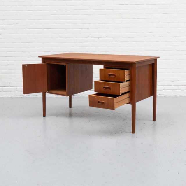 1960s desk from Denmark, made of teak. Featuring three drawers and a practical storage compartment. Nicely finished, with...
