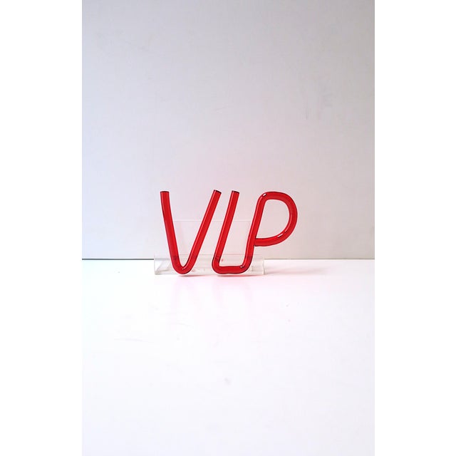 An acrylic VIP business card holder, Postmodern design period, circa late-20th century. VIP is in red translucent acrylic,...
