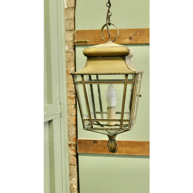 This is a Large brass Lantern it has a natural darkened patina, the Lamp has 4 glazed sides with a door on one of these to...