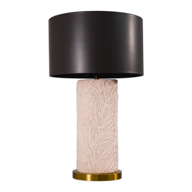 A stylish pair of table lamps featuring textured pink ceramic bases adorned with an intricate flower and leaf relief...