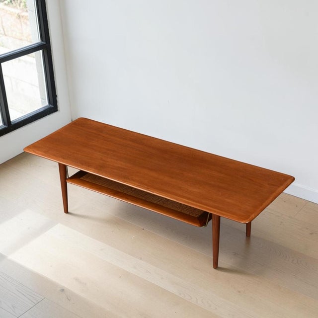 Stunning early Danish Modern teak coffee table by Peter Hvidt and Orla Mølgaard Nielsen for France and Son. The masterful...