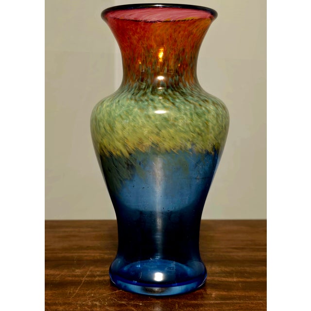 A striking hand‑blown art glass vase by Flux Studio, featuring the vibrant multi‑color gradient the studio is known for....