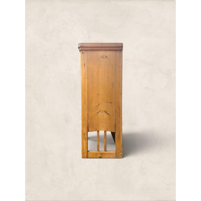 An antique English pine hanging kitchen cupboard dating to circa 1890. Featuring glazed double doors and a beautifully...