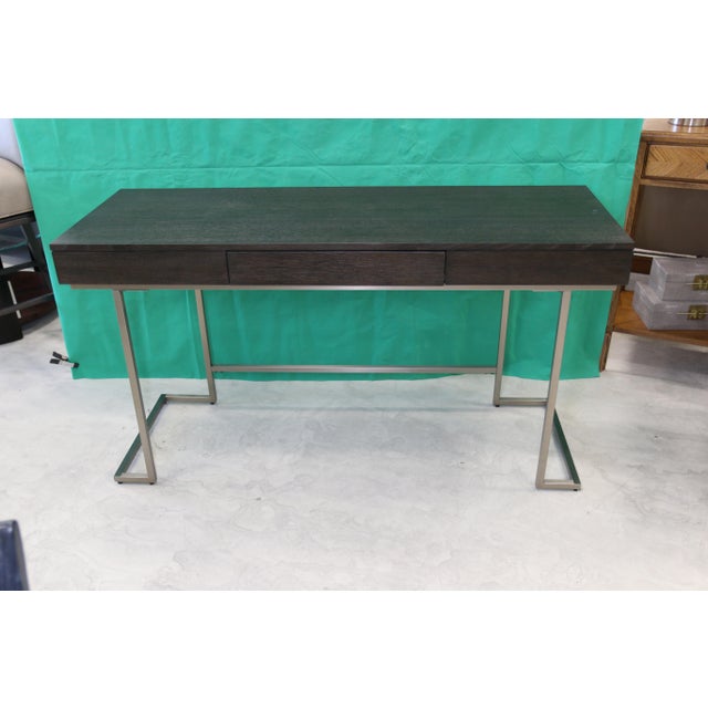 Description Impression is everything in a chic modern living space, and this single-drawer desk delivers on style and...