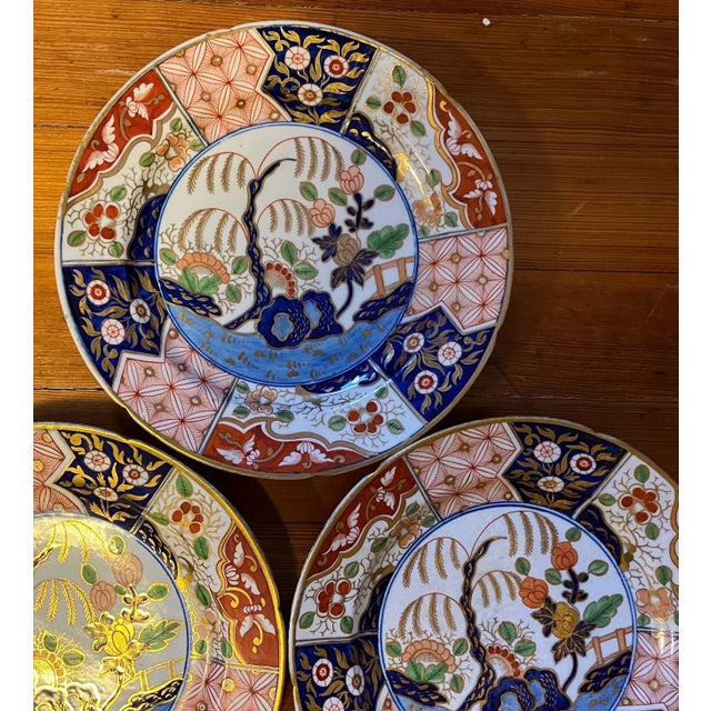Three antique Coalport porcelain imari plates decorated in the rock and tree pattern made famous by the Prince Regent at...