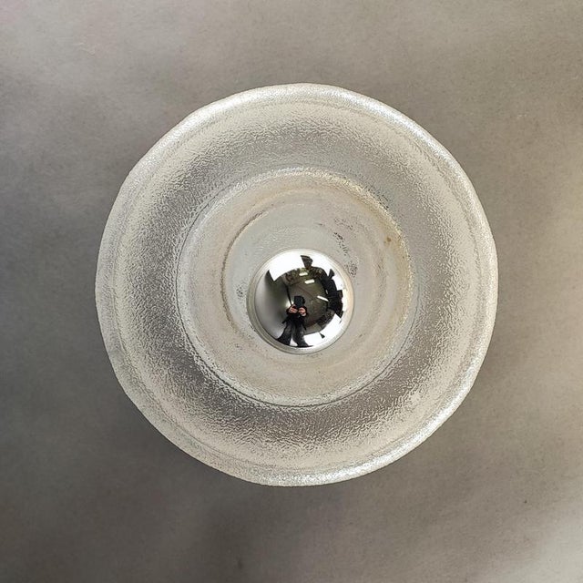 A pair of cylindrical wall lamps with three rings cast in a single murano glass mold. They create a warm light that...