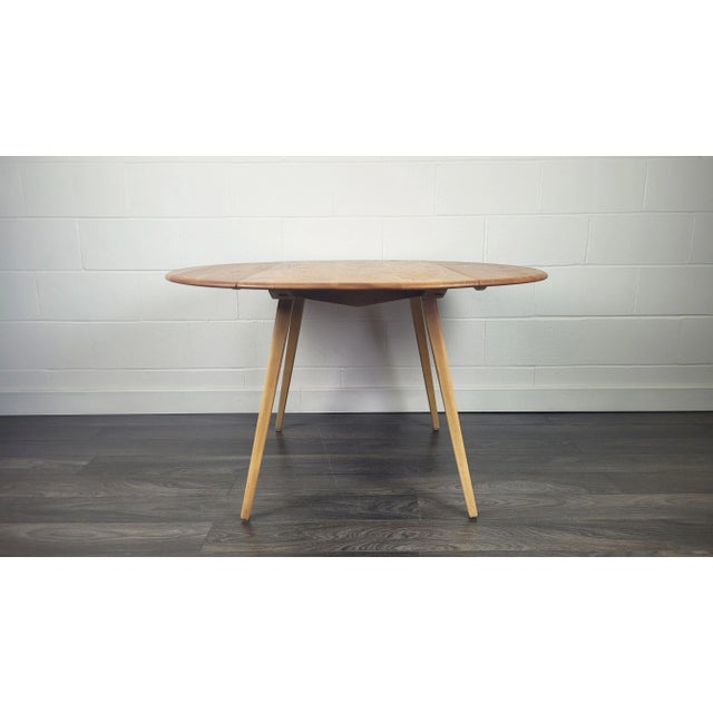 - Solid English Elm wood drop leaf table with Beech wood splayed legs - Produced by Ercol during the 1960s - Width - 123.5...