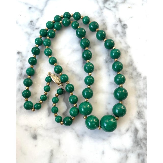 Add a touch of vintage charm with our 23" Green Nephrite Jade and Goldtone Beaded Necklace. The perfectly round nephrite...