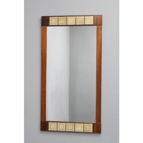 This refined Danish mid-century wall mirror dates to the 1960s and showcases the timeless elegance of Scandinavian modern...