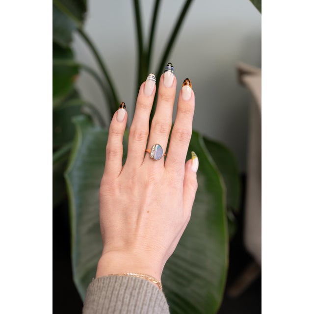 Featuring a 3.37ct boulder opal alive with fiery color, accented by natural diamonds for extra sparkle. Set in solid 14K...