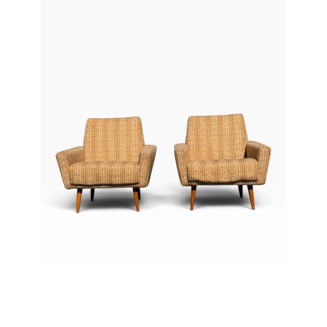 OVERVIEW A matched pair of mid-century Danish modern lounge chairs with a strong geometric silhouette. The deep seats and...