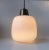 This large gourd-shaped pendant lamp is made of matte opaline glass with a brass mount and tube. The light is in the style...