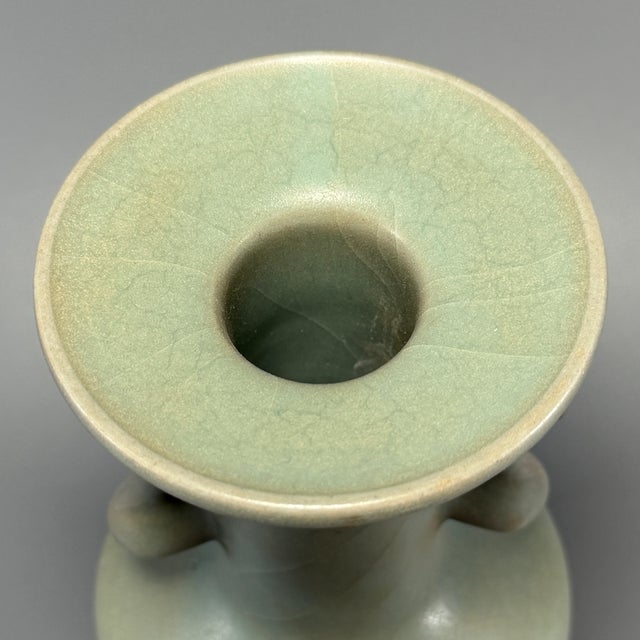 This is a premium antique Chinese Longquan celadon vase, decorated with elegant phoenix‑form double handles. It presents a...