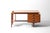 A striking writing desk from the 1960s featuring a wide writing top, three drawers and a geometric book shelf to the side.