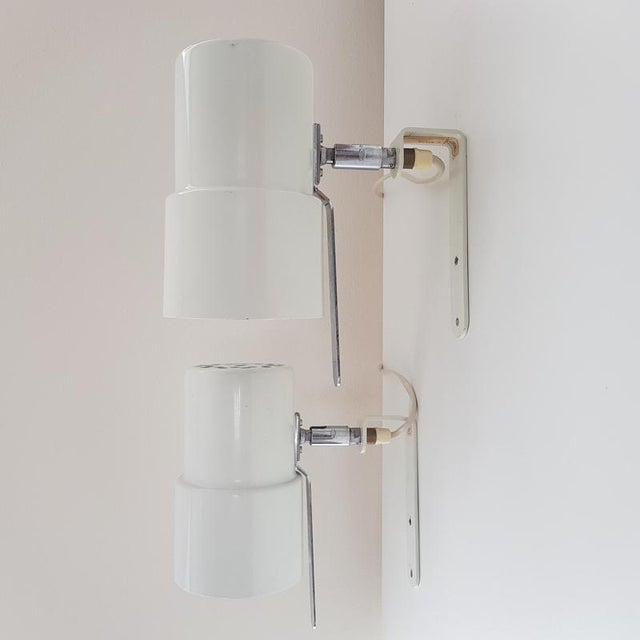 Timeless pair of wall sconces model V-324 designed by Hans-Agne Jakobsson. Sweden, 1960s White lacquered metal with slight...