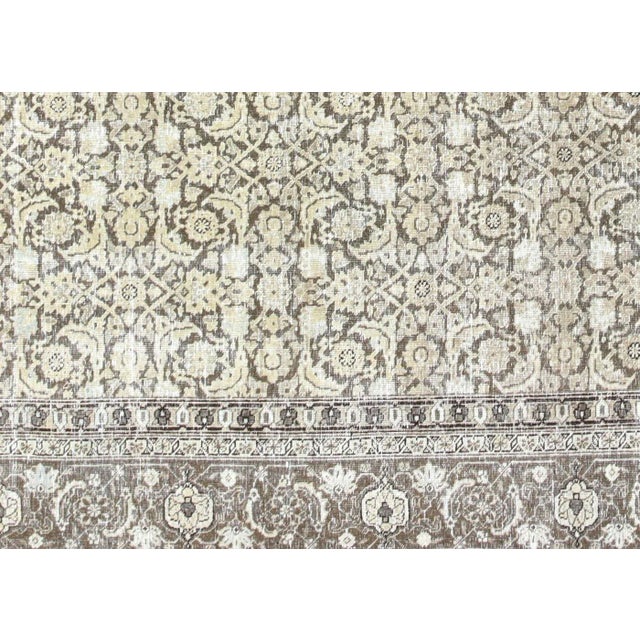 1940s Persian Tabriz Carpet. Hand woven in the Tabriz region of Northern Iran. Distressed and refinished in the U.S. These...