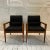 Pair of black vinyl and wooden Jens Risom chairs.