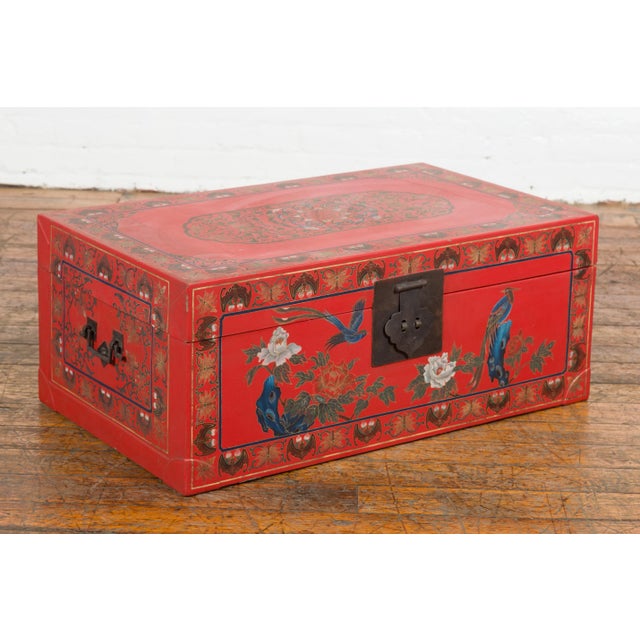 A vintage Chinese red lacquer blanket chest from the Mid-20th Century with egret bird motifs and friezes of bats and...