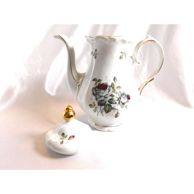 This is a white Winterling teapot in the Bavarian Rose pattern. I do not have date for the pattern. It has a grey rose...