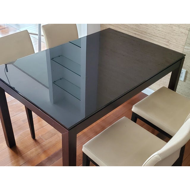 Authentic designer Calligaris dining table with mahogany legs and frame, and black tempered glass top. Made in Italy....