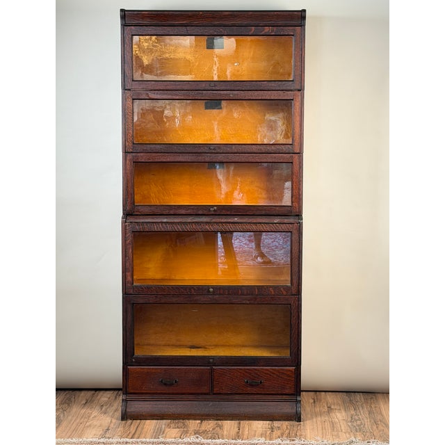 This handsome antique five-stack barrister bookcase dates to circa 1910 and bears its original label for “The Hale System...
