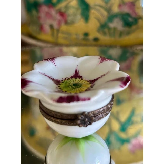 Limoges porcelain trinket box, hand-painted in France and finished with fine detail and rich color. The box features a...