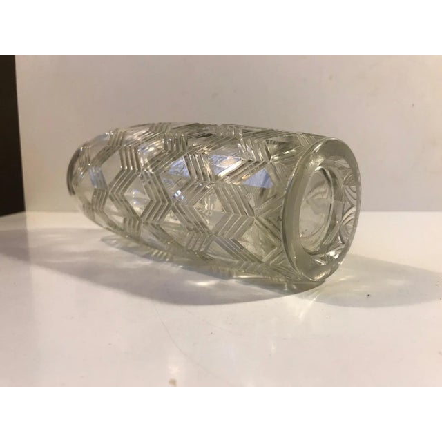 A cast glass vase decorated with arrow motifs. Made in Denmark during the 1930s, probably by Lyngby Glas. The style of...