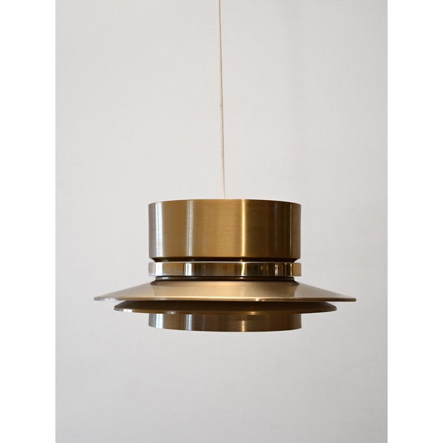 Chandelier designed by Carl Thore for Granhaga in the 60s, in brass, with a geometric and refined design. Chandelier...