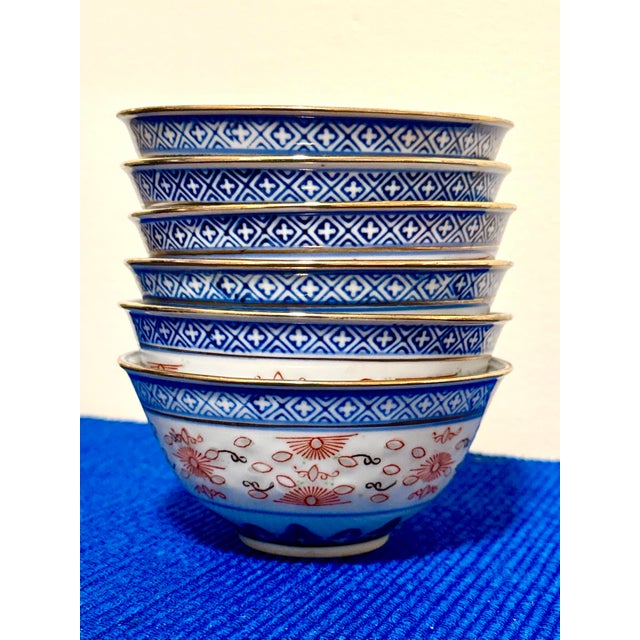 Set of six vintage Chinese rice‑grain porcelain bowls featuring a vivid cobalt dragon motif on the interior and...
