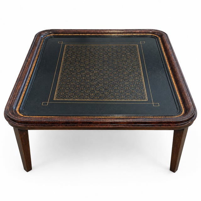 A handsome 20th-century tray top side table featuring a black lacquered surface with elegant gilt-tooled geometric...