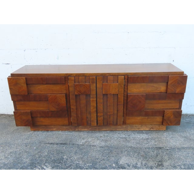 This magnificent Dresser is made of wood, walnut, and veneer. The Dresser was made by Lane Furniture and it is stamped....