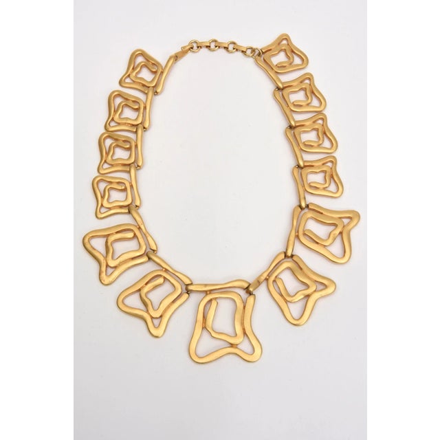 This sculptural gold plated 90's collar abstract design, necklace and cuff bracelet set is a beauty. They can be worn...