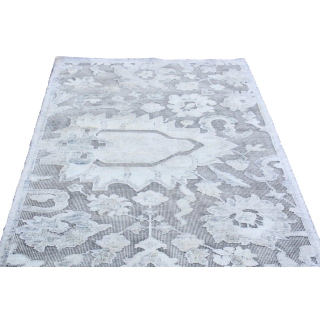 Originating from India, this contemporary rug is hand-knotted with oxidized, high-quality wool and lustrous silk,...