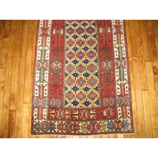 Spectacular tribal Kurdish runner with excellent pile and color, circa 1910. Measures: 2'9” x 14'6”.