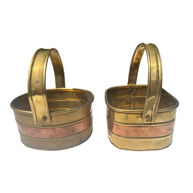 Mid-20th Century Set of Two Vintage Brass & Copper Baskets A striking pair of mid-20th-century decorative baskets crafted...
