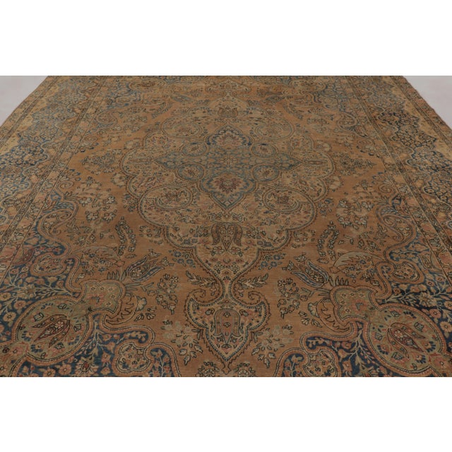 Hand-knotted in wool circa 1920–1930, this 11x15 antique Persian Kerman Lavar rug is a monumental addition to Rug &...