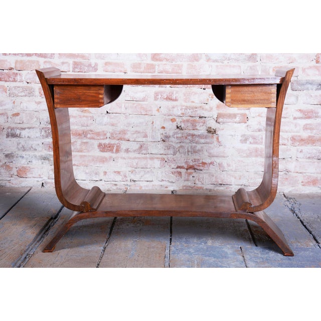 This elegant Art Deco console table comes from France from the first half of the 20th century. It is made of solid wood...