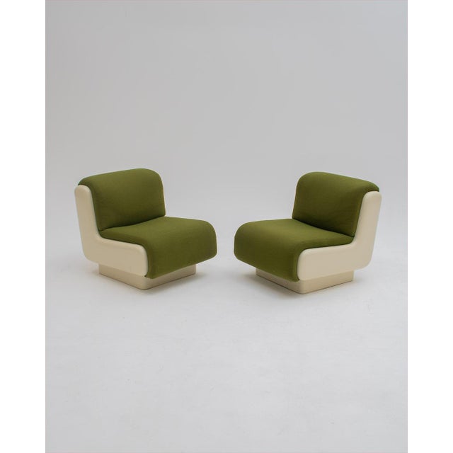 Iconic space-age lacquered wood armchairs with original green upholstery. Their spectacular shape and profile make them...