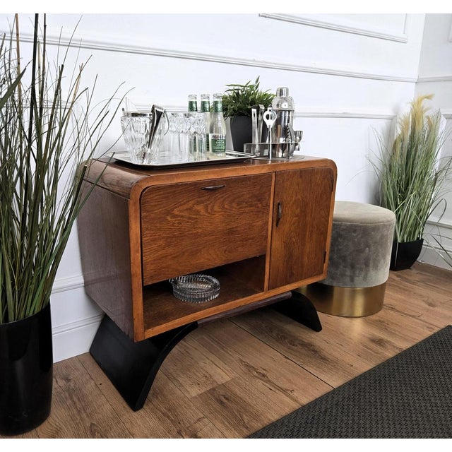 Very elegant Italian Art Deco Mid-Century Modern dry bar cabinet, in beautiful wood, two doors and brass handles. When...