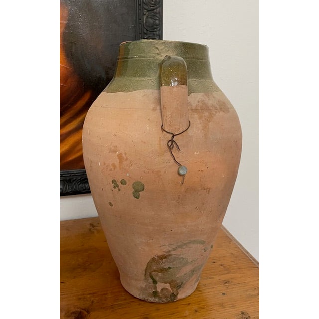 Beautiful European terracotta olive oil jar from circa early 1900's with green glaze, two handles and rustic character....