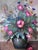 This original vintage oil painting from the 1960s shows a vibrant bouquet of wildflowers arranged in a ceramic vase....