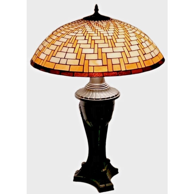 For you to consider is a vintage late Arts & Crafts era "Basket Weave" leaded stained glass bronzed metal table lamp....