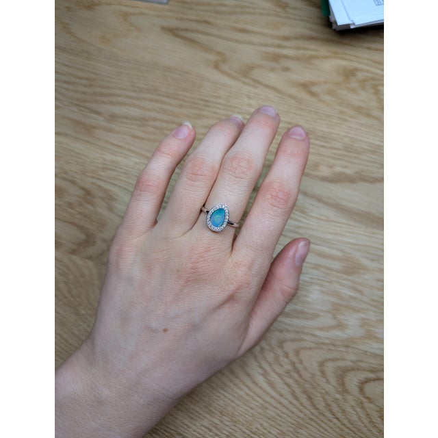 This ring is a breathtaking masterpiece that showcases the mesmerizing beauty of a 1.08ct Boulder Opal. Set in stunning...