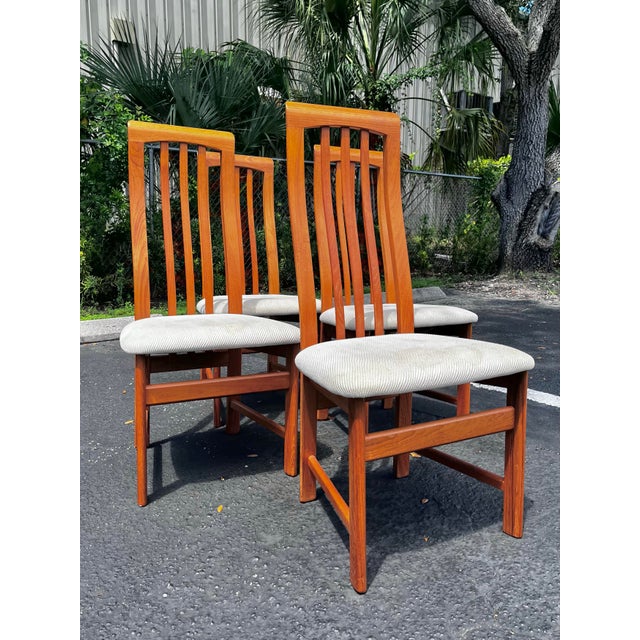 Mid-century modern teak dining chairs. Set of four by Nordic Furniture, made in Canada. A modern and sleek set of chairs....