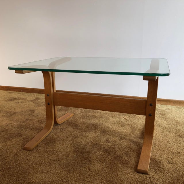 One authentic Ingmar Relling Siesta glass side table with teak frame. The glass and frame are in excellent condition. The...