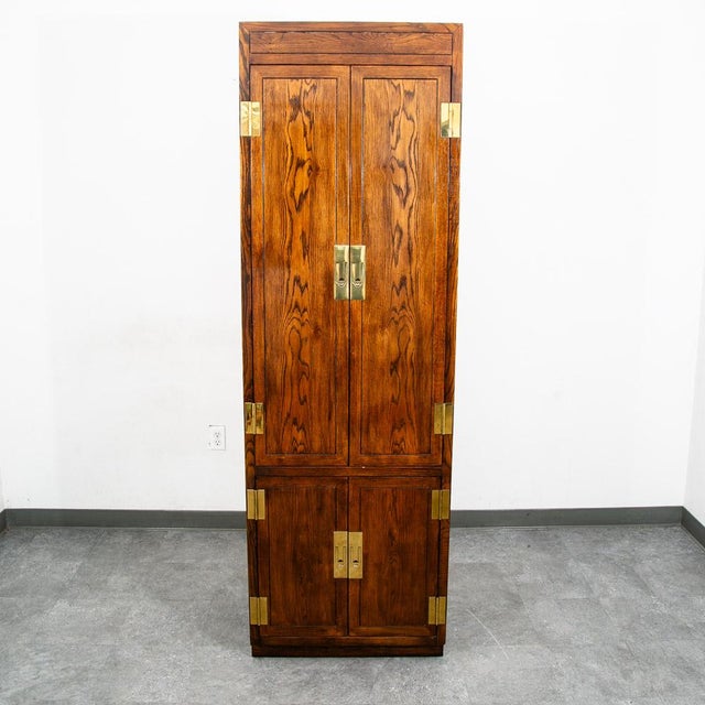Campaign style armoire by Henredon from the Scene One collection. Dark walnut with brass hinges and latch pulls....