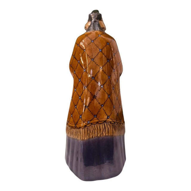 This figure is a ceramic sculpture of the "Churchgoer," designed around 1918 by Franz Schleiss for the Vereinigte Wiener...