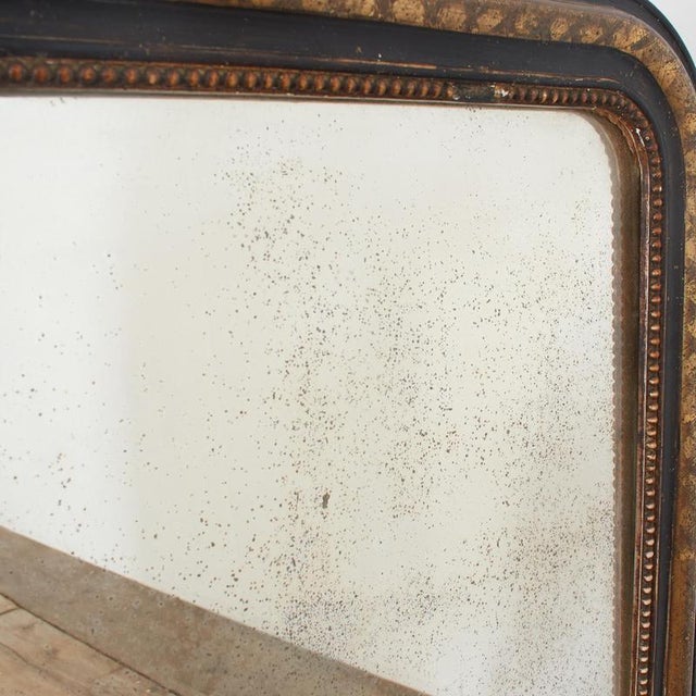 Antique French Louis Philippe Foxed Glass Mirror A charming black Louis Philippe mirror with beautifully foxed mercury...