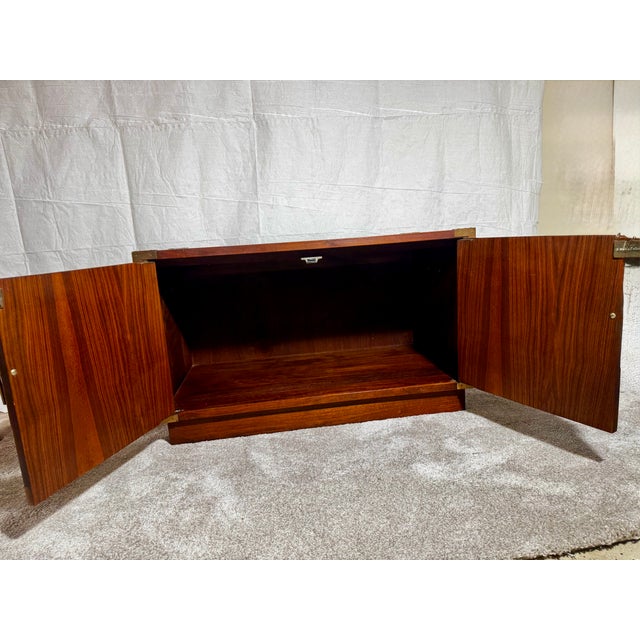 Attributed to Jack Cartwright for Founders, this striking mid-century modern walnut cabinet showcases the sophisticated...